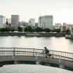 Portland from over the river while a biker goes across a bridge.