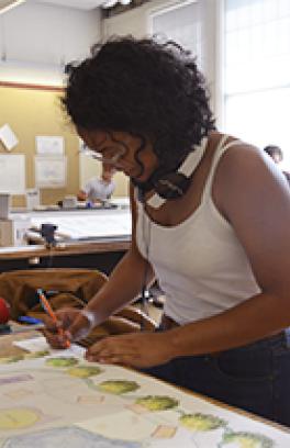 Architecture Summer Immersion Program student works on a drawing in studio.