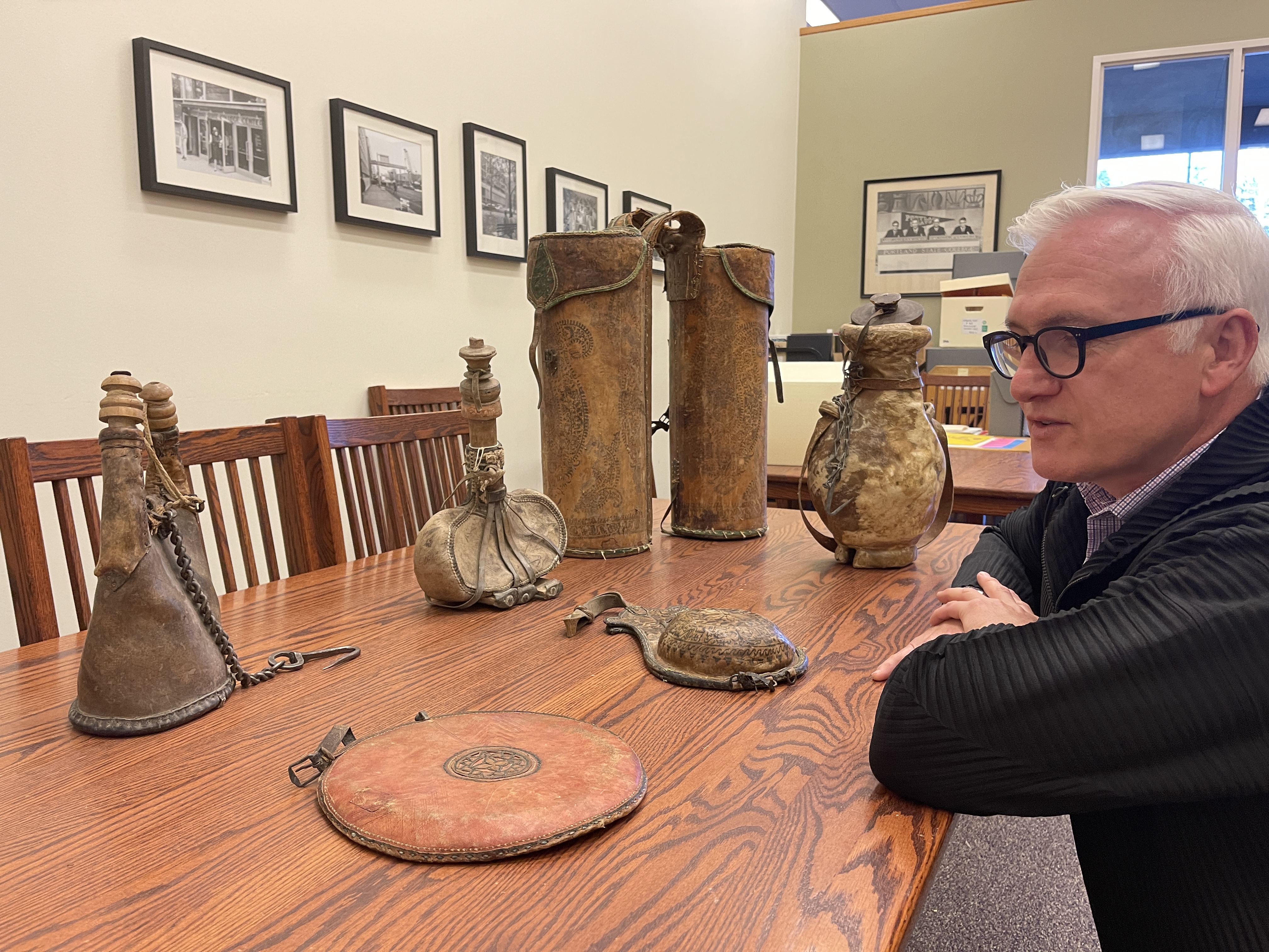 David Roxburgh sits at a table with Islamic objects from the PSU Special Collections