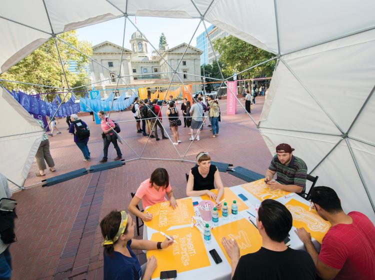 Graphic design students work on a project during a Design Week Portland event at Pioneer Courthouse Square