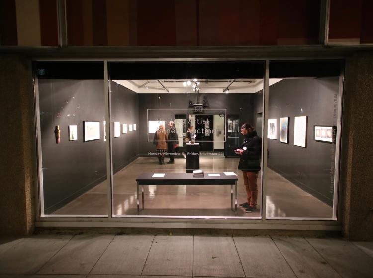 People in AB Gallery viewed through windows from exterior at night