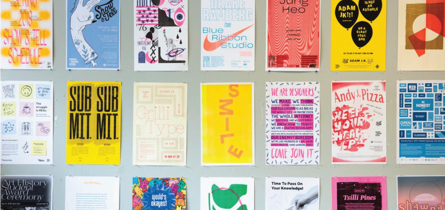 Wall filled with posters created by students in A+D Projects courses.