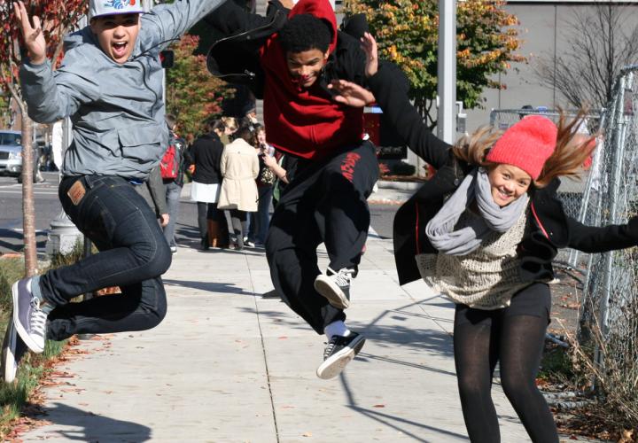 Three students jumping for joy