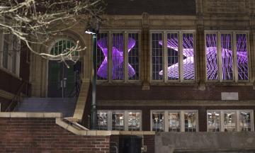 Animated light projection on the windows of Shattuck Hall during the Portland Winter Light Festival
