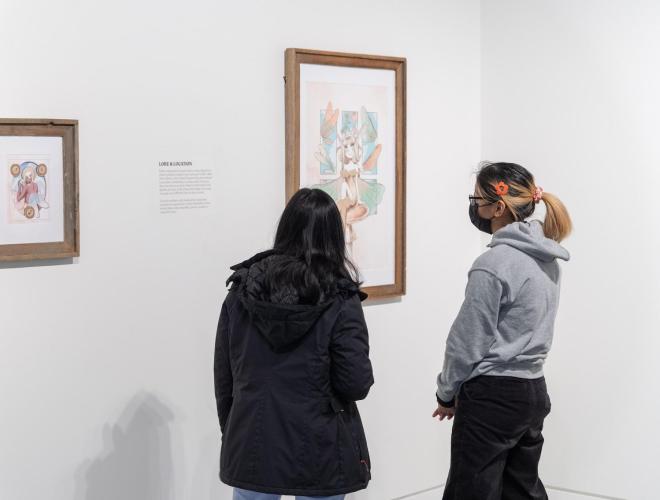 Two museum visitors viewing artwork.