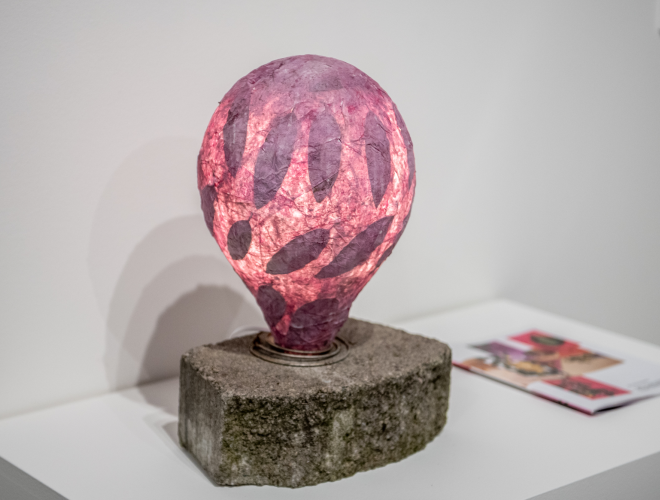 Red paper orb, illuminated from within. This orb is pictured in a nearby ball point pen drawing.