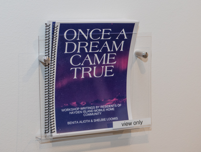 "Once a Dream Came True" publication in a plexiglass wall rack.
