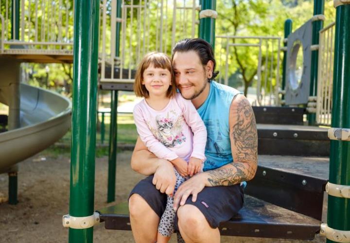 Jeff Martinez with his child at a playground