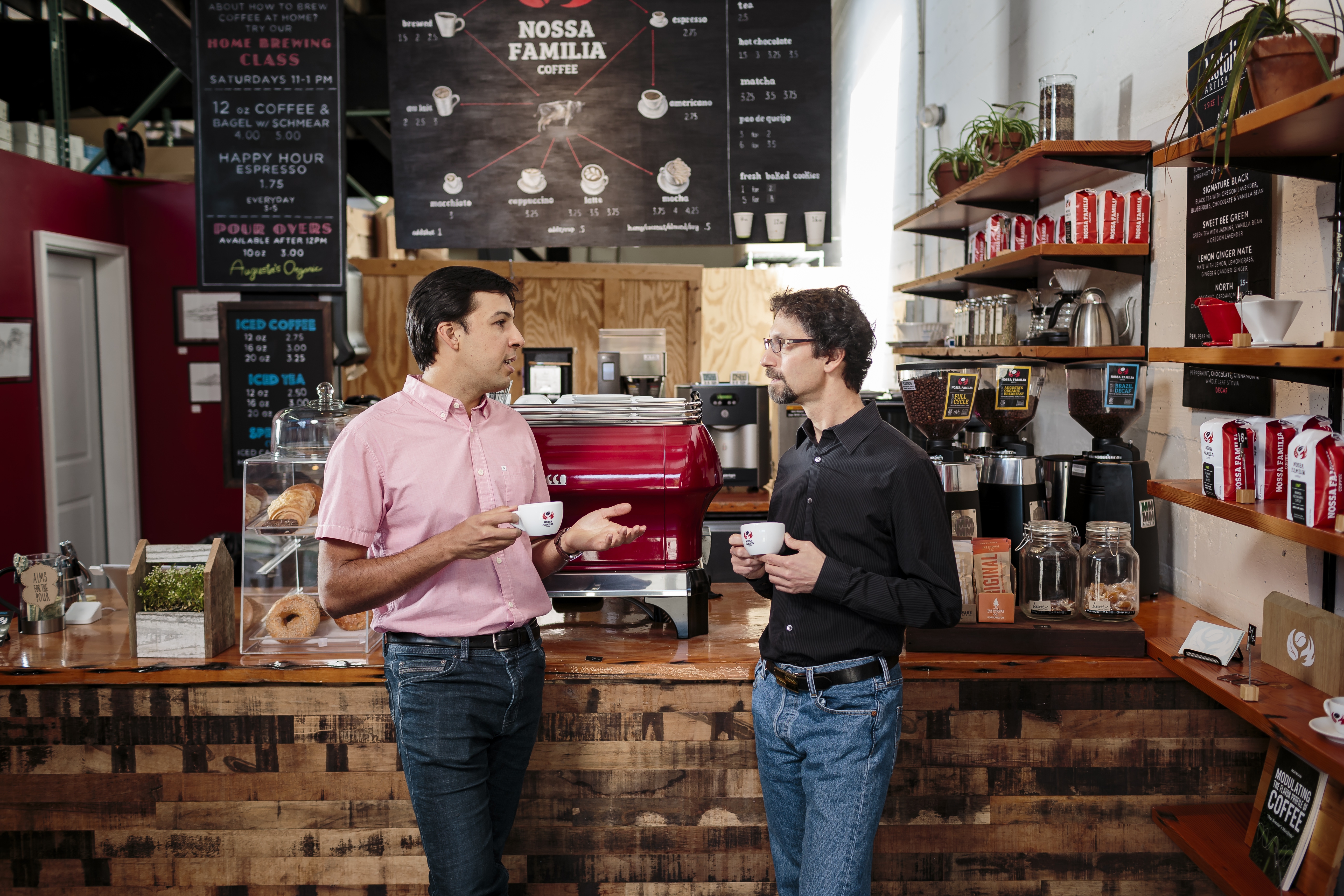 Two people talking at Nossa Familia Coffee 