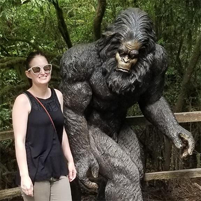 Karrah Jones posing with a gorilla statue