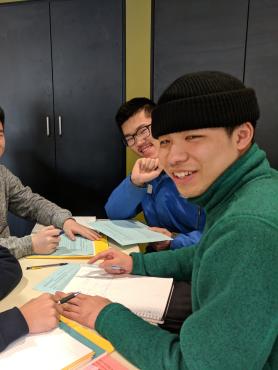 A group of students studying together at a table.