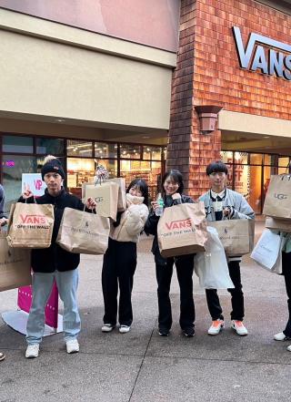 Students with shopping bags at Outlet Mall