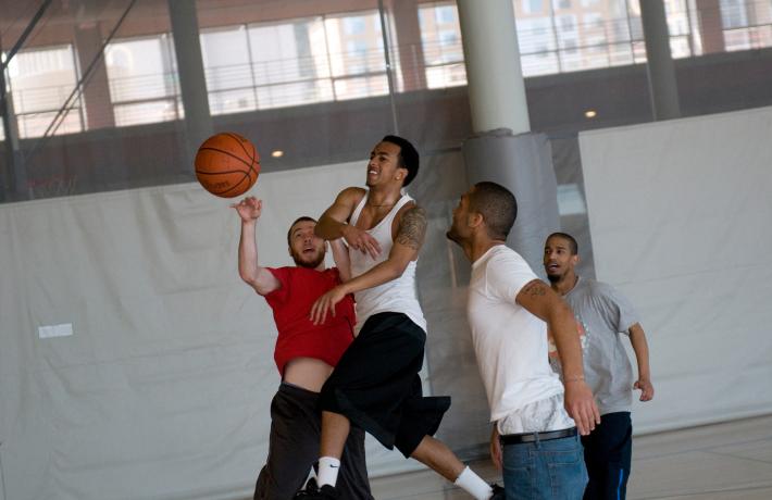Several students playing basketball.