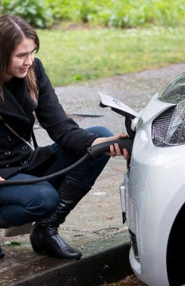 portland state university sustainability program student charging an electric car