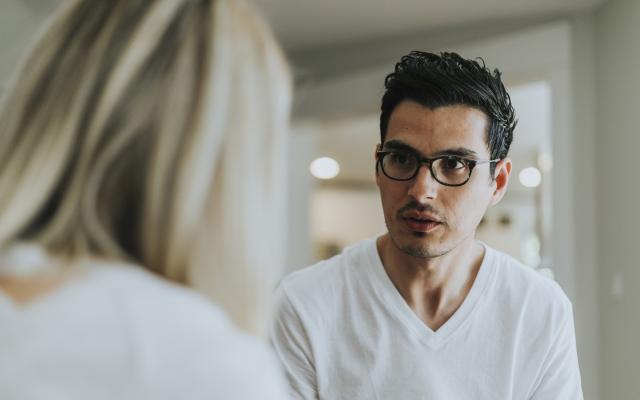 Bespectacled man receiving therapy