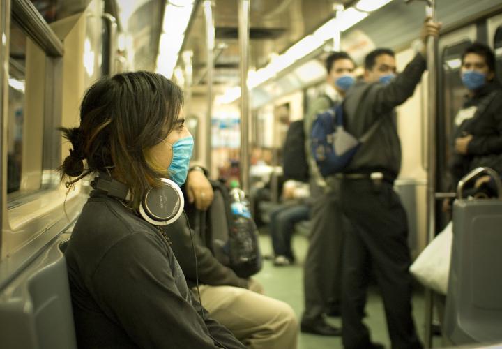 Person wearing mask on public transportation