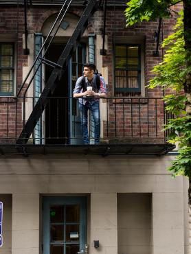 student leaning on balcony