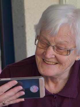 Woman showing phone to older woman