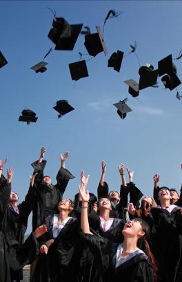 Image of graduates tossing hats