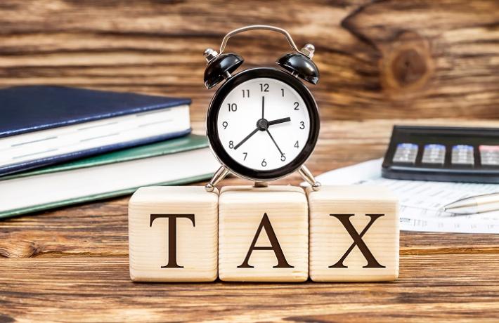 Image of the word "Tax" with ticking clock