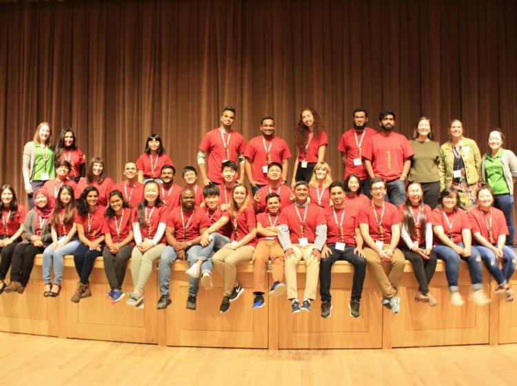 International student mentors stand together for a group photo during orientation.