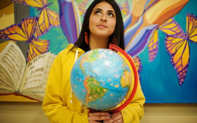 Student holding globe