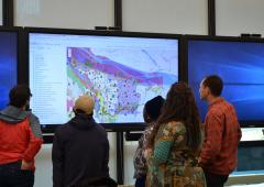 Group of people looking at map displayed on projector