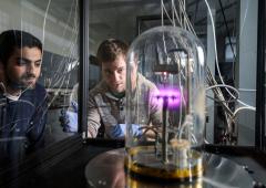 Two students looking at science equipment in lab