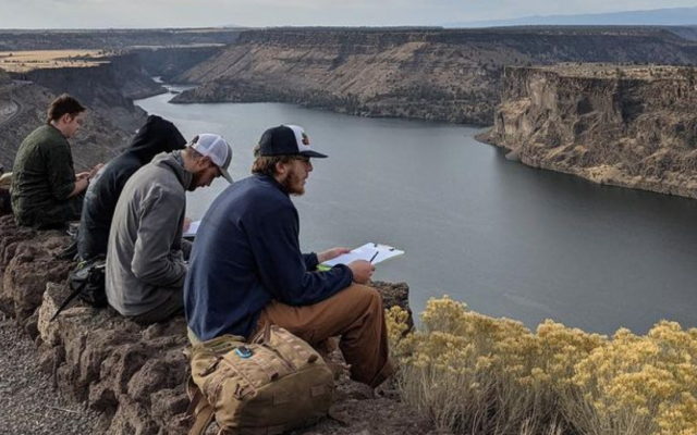 Geology students overlooking lake during field trip