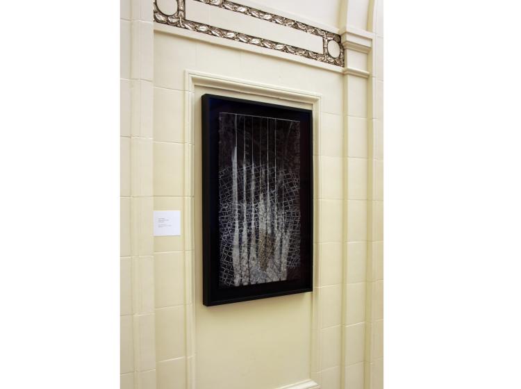 One of the framed artworks is shown on the wall in Lincoln Hall, viewed at an angle