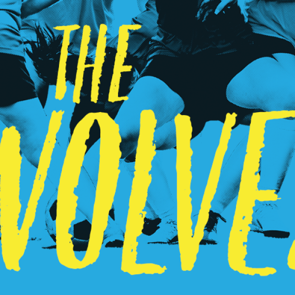 Title of the play "The Wolves" in yellow on top of an image of legs of soccer players.