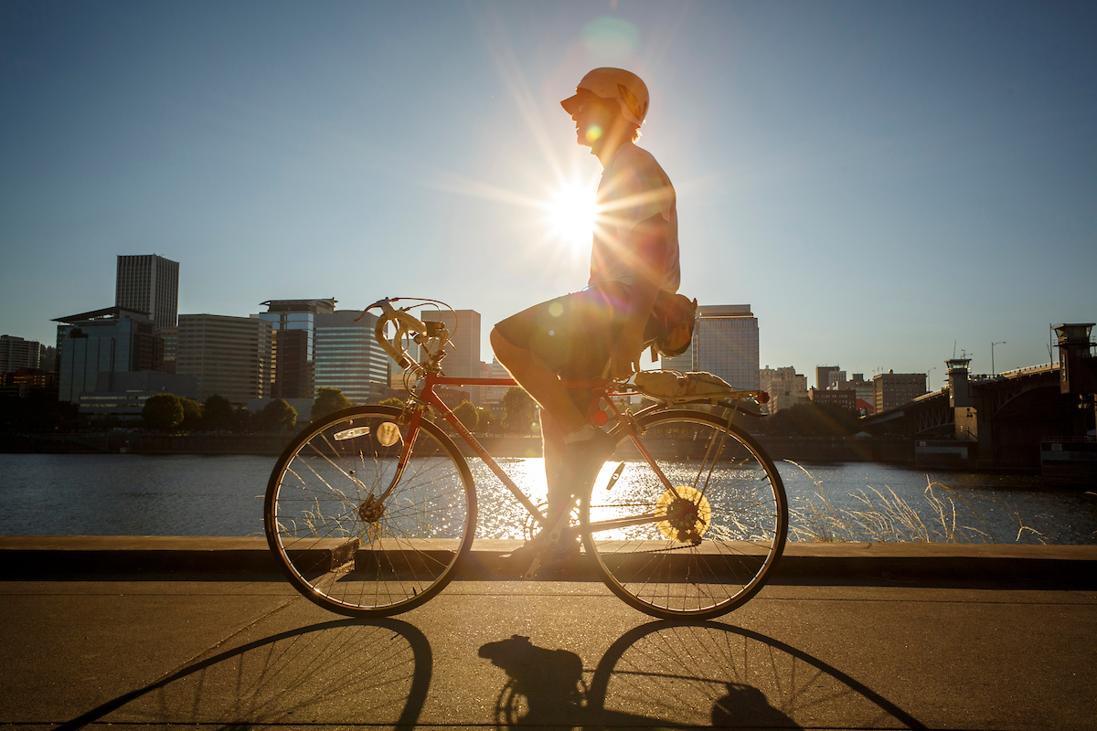 Person Biking on Waterfront (Portland Cityscape in Background)
