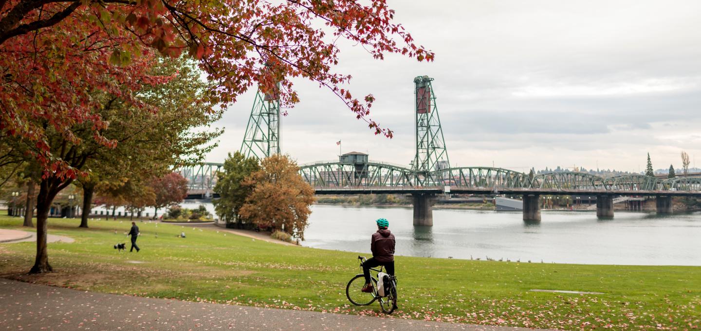 Portland Waterfront in Fall, Hawthrone Bridge in Background, Person on Bike in Foreground