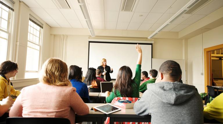 Portland State University Economics professor standing in front of a class