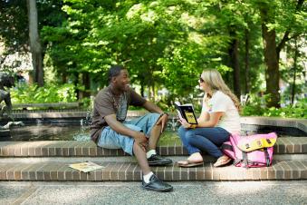 two Portland State University graduate creative writing students studying in a park