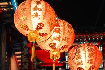 three lit chinese hanging lanterns