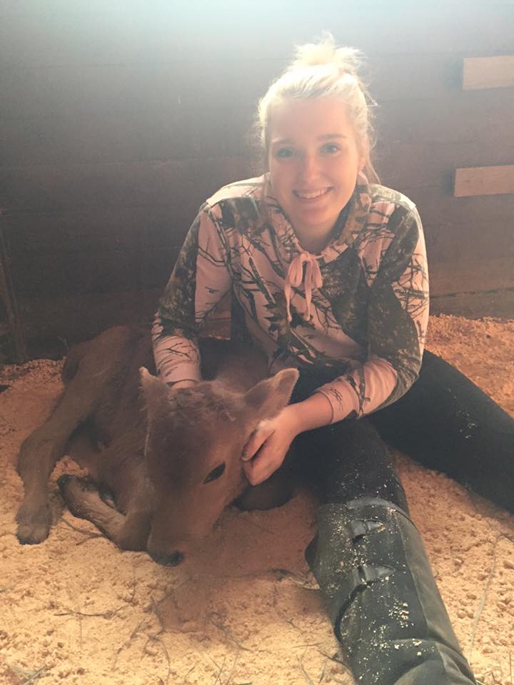 Emma Vandehey holding a baby cow