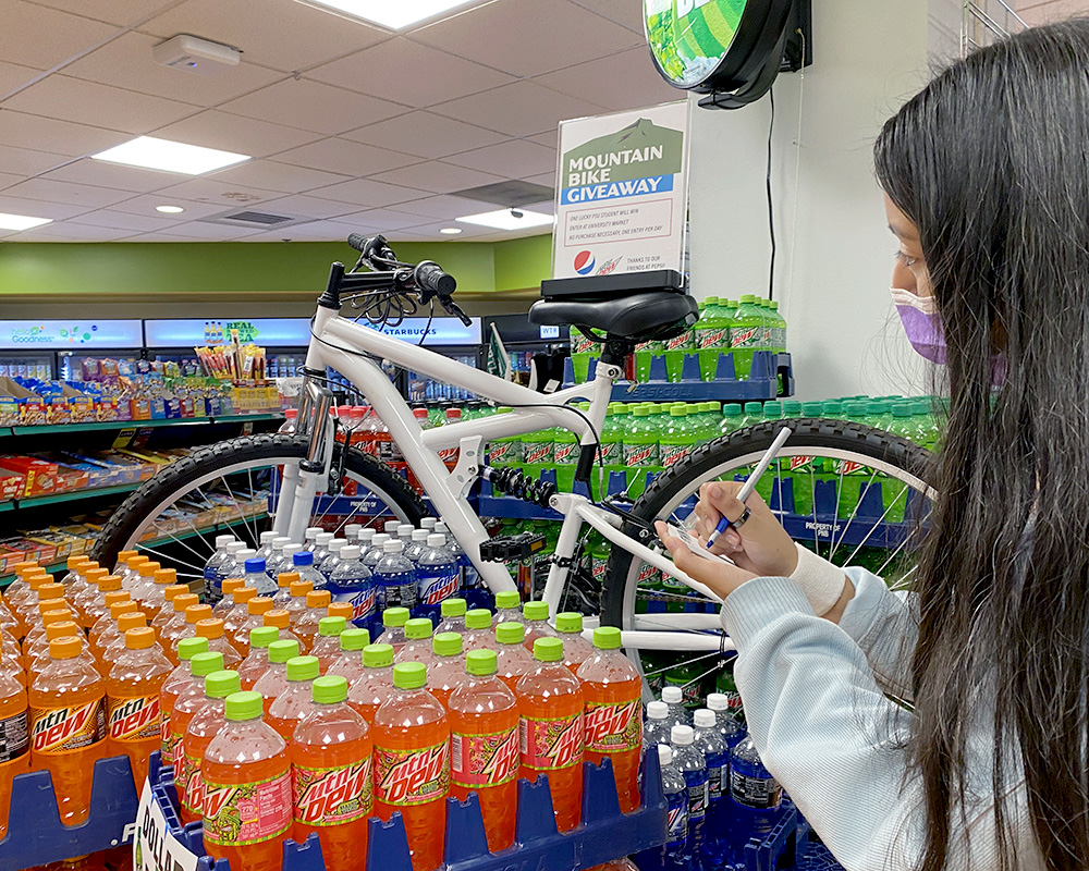 A bike is on display amid a stack of Mountain Dews during a recent University Market giveaway.