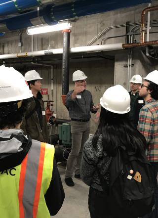 students in hard hats in mechanical room of student rec center