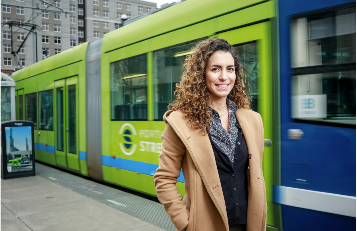 Student in front of Portland Streetcar
