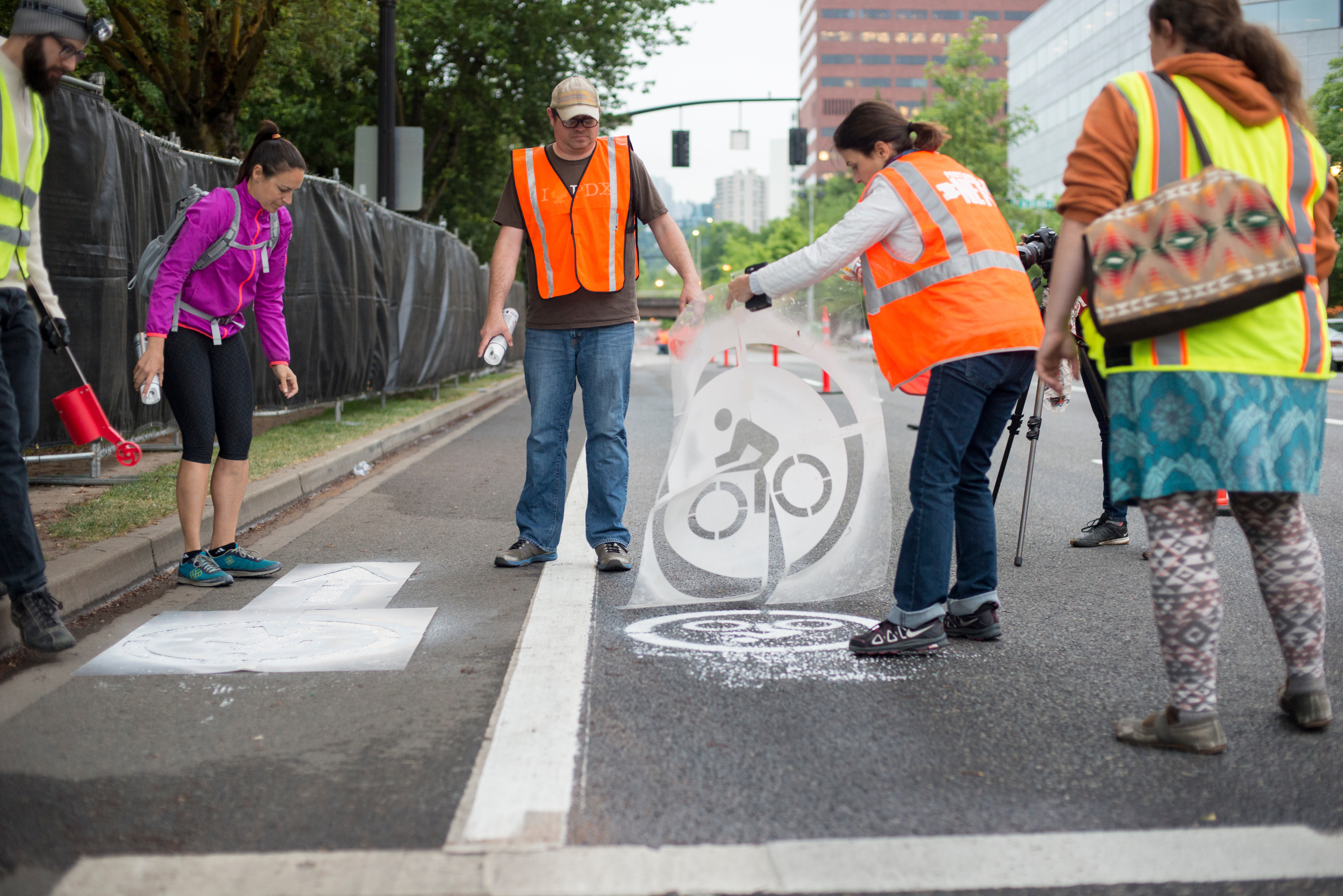 Photo of students painting bike lane on Naito Parkway