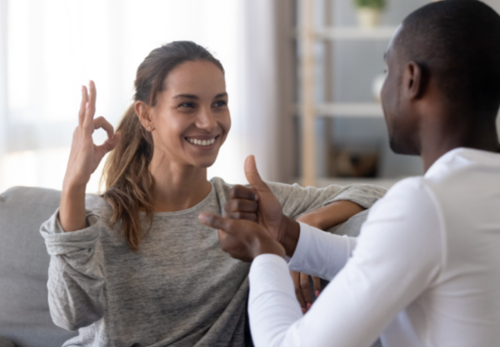 Two people having a conversation using sign language