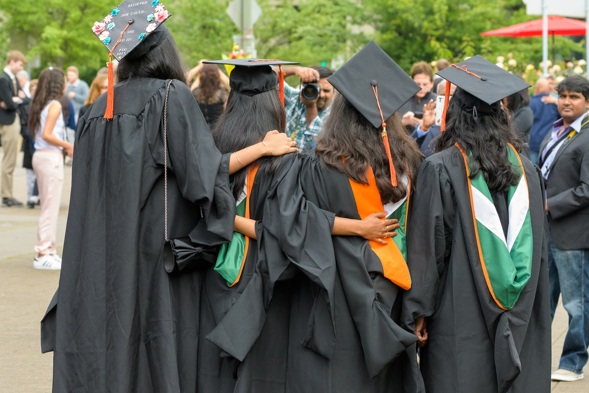 Four graduates posing for a photograph
