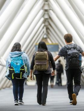Students walking wearing backpacks
