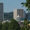 The iconic 'Made in Oregon' sign peaking behind multiple trees.