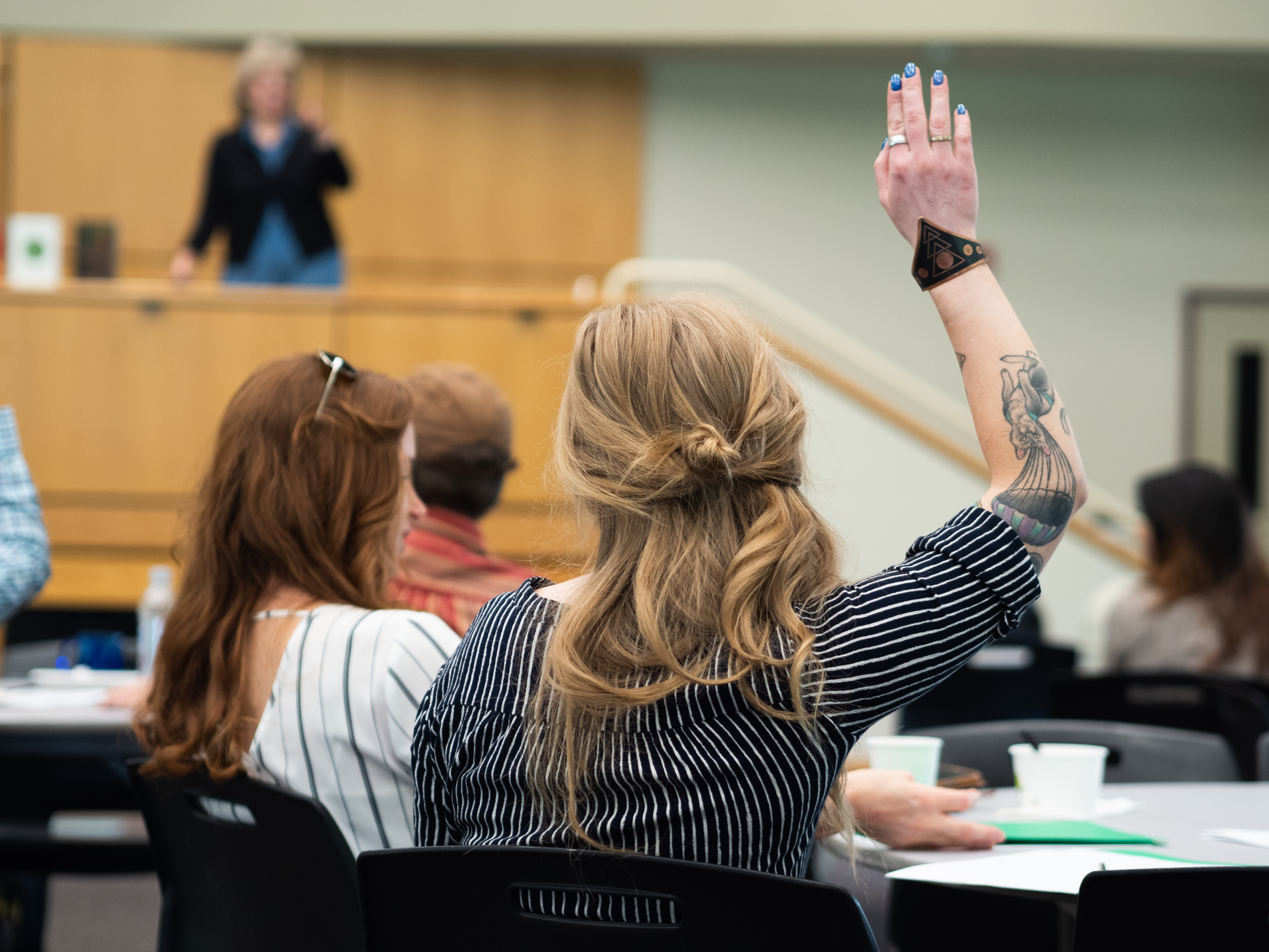 PSU graduate student raising hand in conference