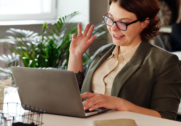 faculty member waving at computer