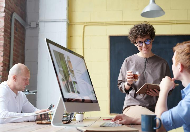 faculty talking with support staff at the Office of Academic Innovation