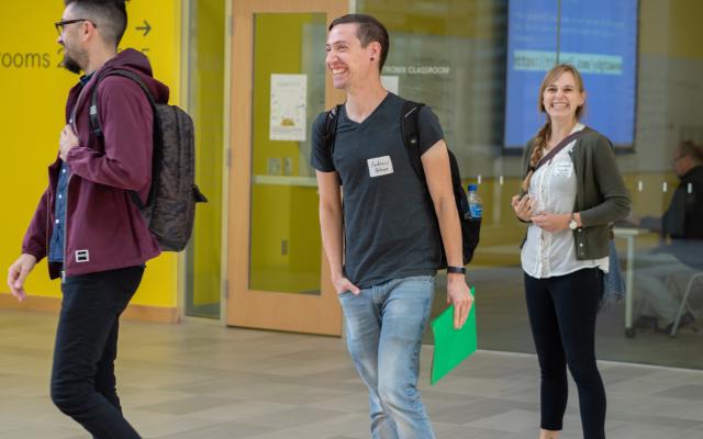 students walking and smiling at conference
