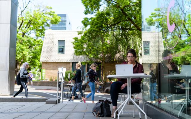 student outside with computer
